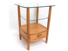 An Ercol light elm & glass occasional table, 25.25in tall