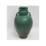 A green glazed garden urn, 24.25in tall x 14in wid