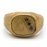 A 9ct gold signet ring set with three small garnet