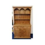 A compact, farmhouse pine dresser, with recessed d