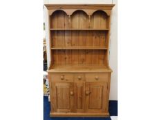 A compact, farmhouse pine dresser, with recessed d