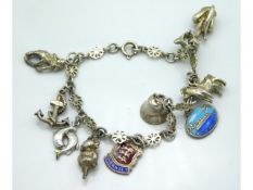 A silver charm bracelet including cat, anchor, fis