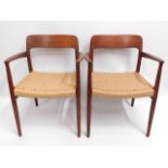 A Danish teak mid century retro dining suite of two carvers & four chairs with original rush seats b