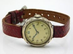 A silver cased early 20thC. wrist watch with snake