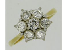 An 18ct gold daisy style ring set with approx. 0.7ct of diamond, size L/M, 3.1g