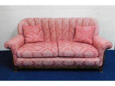 A c.1940's upholstered two seater sofa with scalloped back, 67in wide x 30in high to back