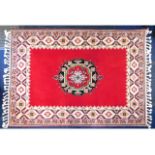 A Moroccan wool rug, 88.5in x 55.25in inclusive of fringe