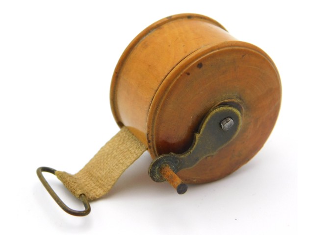 A 19thC. treen walnut tape measures, 25mm diameter