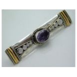 A white & yellow metal brooch set with amethyst, 4
