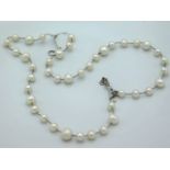 A silver mounted pearl necklace, 25in long, 53.6g