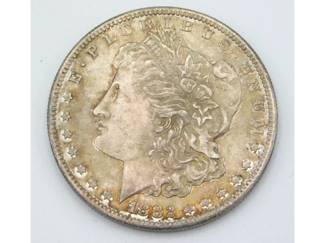 An 1882 silver US one dollar coin, 26.8g