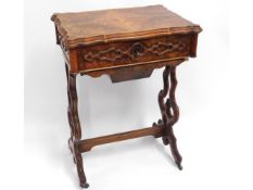 A 19thC. walnut work table with carved decor, 21.5
