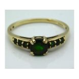 A 9ct gold ring set with possibly tsavorite, some