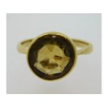 An antique 18ct gold ring set with yellow stone, possibly tourmaline, size L/M, 3.7g