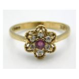 A 9ct gold ring set with diamond & ruby in floral