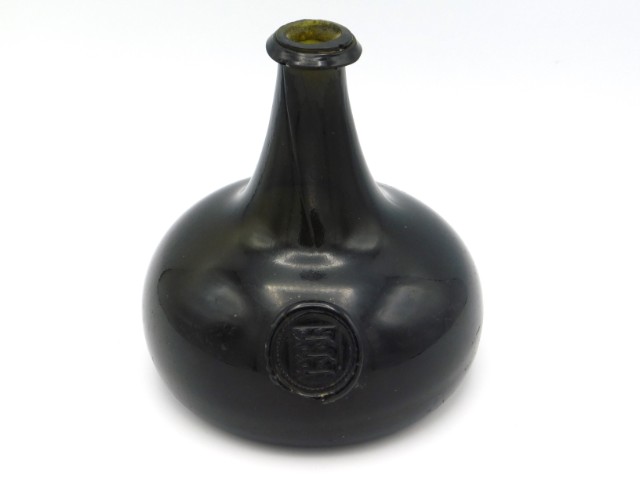A small 18thC. glass onion seal bottle with three lions Arms of Carew, from the Manor of Haccombe, N