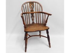 An 18thC. elm & yew wood Windsor chair with crinoline stretcher, some old worm damage, treated, 35.5