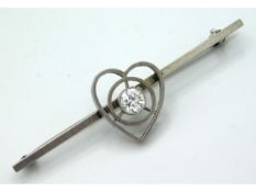 An antique white metal bar brooch set with approx.