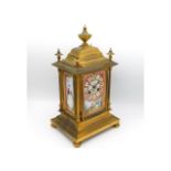 A French 19thC. Le Roy & Fils gilt bronze clock with Sevres style porcelain panels, 14in tall