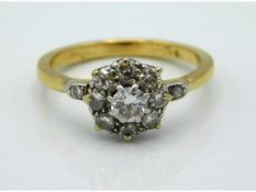 An 18ct gold daisy style ring with approx. 0.45ct