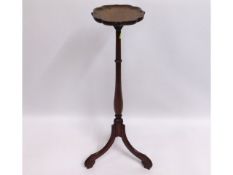 A 19thC. mahogany torchere with scalloped tray, 39.5in tall