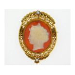 An antique, well carved carnelian & hardstone cameo set within yellow metal mount with pearl, tests