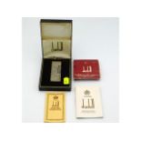 A boxed Dunhill lighter with flints & paperwork