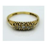 An antique 18ct gold ring set with five small diam