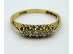 An antique 18ct gold ring set with five small diam