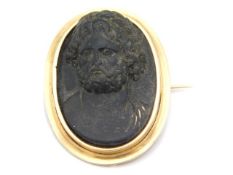 A antique yellow metal mounted carved black stone