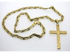 A 9ct gold 20in chain with cross with chased decor