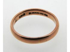 A 19thC. 9ct rose gold band, date letter for 1853,