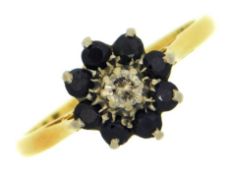 An 18ct gold ring with floral style setting of sap