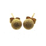 A pair of 9ct gold stud earrings with frosted fini