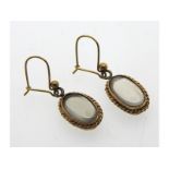 A pair of yellow metal mounted moonstone style earrings, test electronically as 9ct gold, 3.6g, 22mm