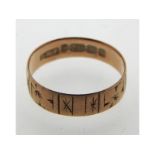 A 19thC. 9ct rose gold band with engraved decor, 1.5g, size O/P