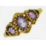 A 9ct gold ring set with three amethyst stones, 1.