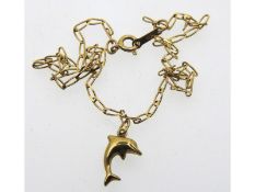 A 9ct gold 10in long anklet with dolphin pendant,