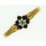 A 9ct gold ring set with floral arrangement of sap