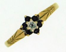 A 9ct gold ring set with floral arrangement of sap