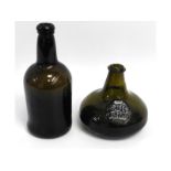 An 18thC. wine bottle, 9.375in tall, twinned with