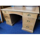 An oak desk with inset brass handles & leather sty