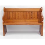 An antique pitch pine church pew, 49in wide x 35in