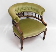 An antique upholstered button back armchair, 25.5i