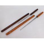 Two concealed short sword batons with carved decor