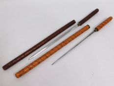 Two concealed short sword batons with carved decor