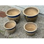 Two pairs of matching garden pots, largest pair 12