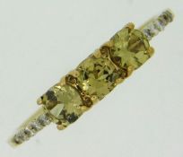 A 9ct gold ring set with diamonds & yellow stones, possibly tourmaline, size N/O, 1.7g