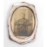A Birmingham silver photo frame with seated soldie