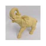 A large ivory coloured resin model of an elephant,